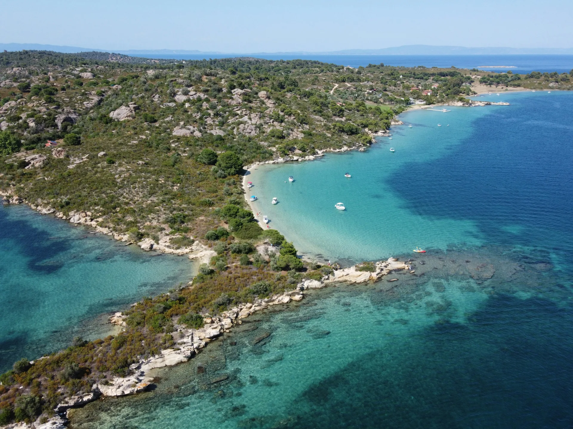 Vourvourou bay turquoise water and a small beach in Sithonia